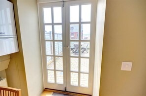A room with a large glass door leading outside, a white radiator, and a light switch on the wall. - 2 Bed in Scarborough (oc-s878) (Scarborough)