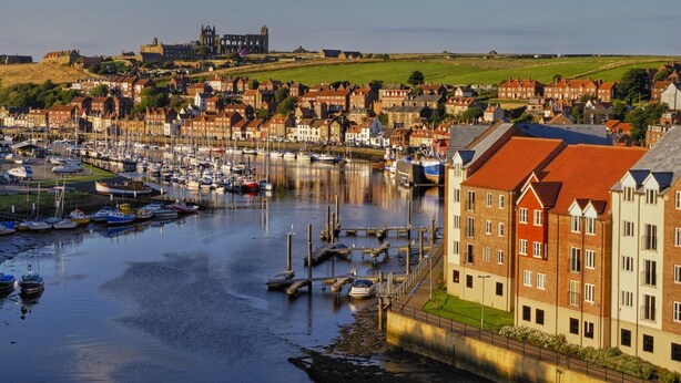 A harbor with boats, a historic building, and residential buildings. - 2 Bed in Whitby (oc-w945) (Whitby)