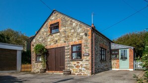 A stone building with a large wooden door, a small window, and a green door. - 3 Bed in Gunwalloe (oc-p00858) (Gunwalloe)