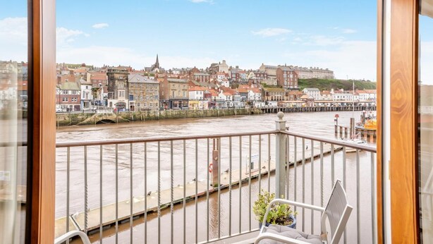 A balcony with a view of a river, buildings, and a bridge. - 2 Bed in Whitby (oc-w794) (Whitby)