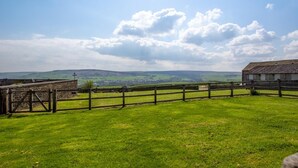 A rural landscape with a stone wall, wooden fence, and a building with a sloped roof. - 2 Bed in Cowling (oc-ds239) (Cowling)