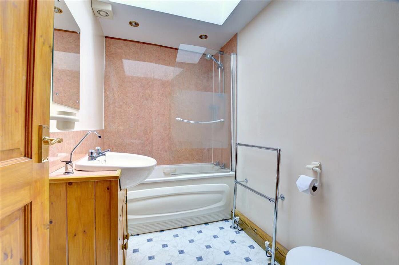 Een badkamer met een wastafel, bad en douche.