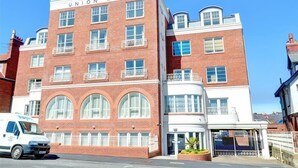 A multi-story building with a prominent "Union Mill" sign, featuring a brick facade, large windows, and a gated entrance. - 2 Bed in Whitby (oc-w814) (Whitby)