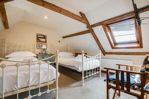 A bedroom with two beds, a wooden chair, a window, and a radiator. - 2 Bed in Whitby (oc-w050) (Whitby)