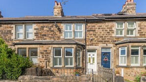 A stone building with multiple windows and doors, featuring a stone facade and a small garden area with a metal fence. - 3 Bed in Harrogate (oc-d32616) (Harrogate)