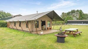 A tented accommodation with a deck, a table, and a fire pit. - 3 Bed in Barsham (oc-g32508) (Barsham)
