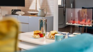 A modern kitchen with a coffee maker, a sailboat decoration, and a fireplace. - 3 Bed in Padstow (oc-p00878) (Padstow)