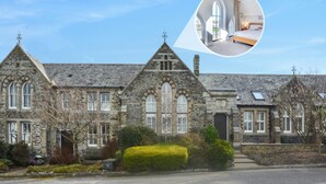 A historic stone building with a large arched window and a smaller window with shutters. - 4 Bed in Padstow (oc-p00011) (Padstow)