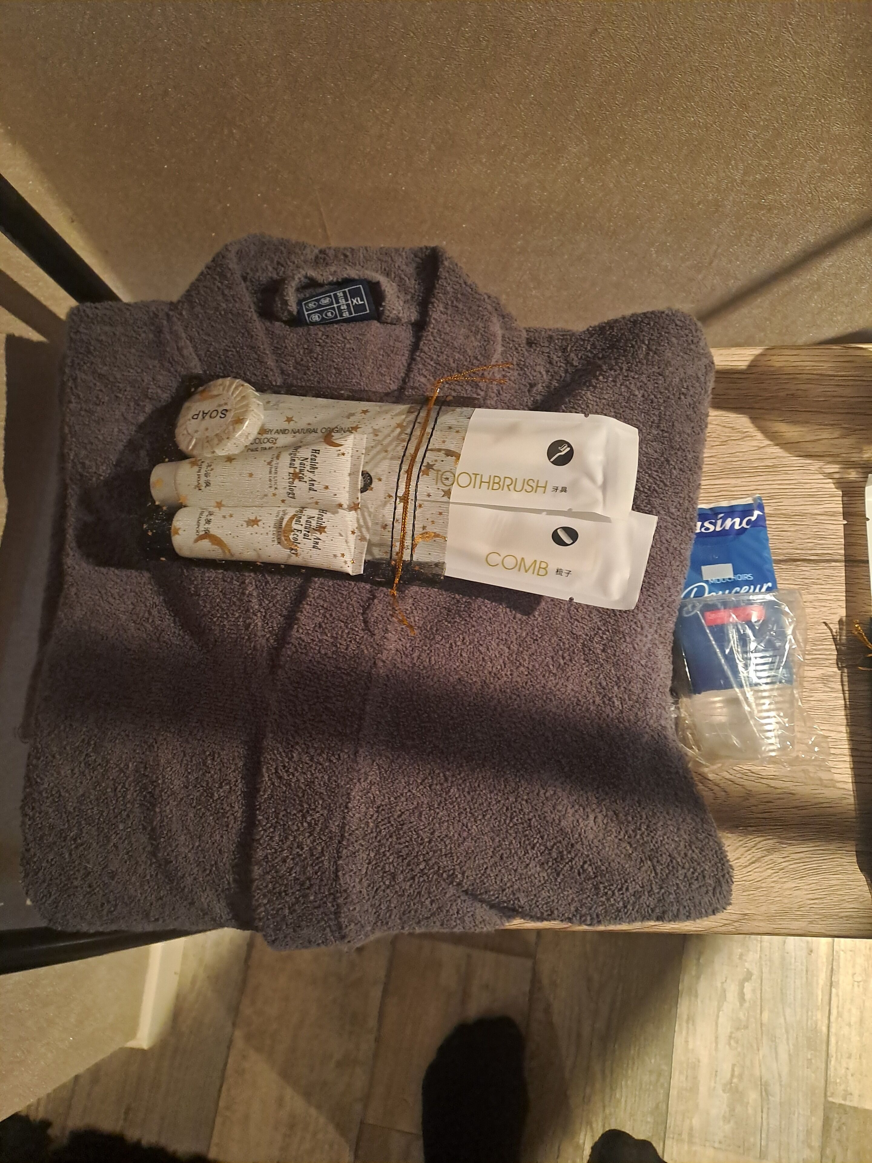 A towel with a toothbrush and comb on it.