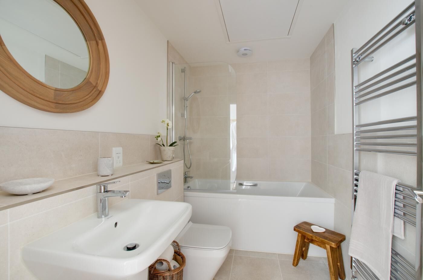 A modern bathroom with a sink, toilet, bathtub, and shower.