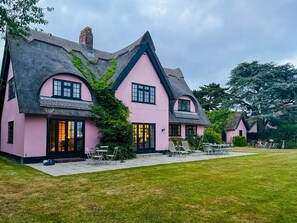 A pink house with a thatched roof and a well-maintained lawn. - 3 Bed in Walberswick (oc-spinn) (Walberswick)