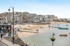 A coastal town with a sandy beach, boats, and a stone wall. - 1 Bed in St. Ives (oc-pc466a) (St Ives)