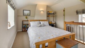 A bedroom with a bed, a bedside table, a bookshelf, a mirror, and a window. - 1 Bed in Bodham (oc-2141) (Bodham)