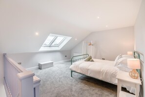 A bedroom with a skylight, a bed, bedside table, and a nightstand. - 1 Bed in Marishes (oc-l32534) (Marishes)
