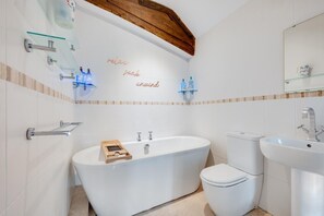 A modern bathroom with a freestanding bathtub, a toilet, and a sink. - 3 Bed in Newbridge (oc-p00869) (Newbridge)