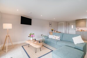 A modern living room with a sofa, a coffee table, and a lamp. - 1 Bed in Marishes (oc-l32536) (Marishes)
