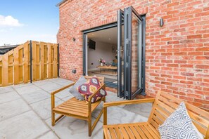 A patio with two wooden benches and a wooden fence. - 1 Bed in Marishes (oc-l32536) (Marishes)