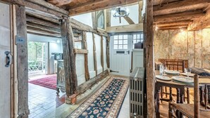 A rustic interior with exposed wooden beams, a traditional dining table set, and a patterned rug. - 2 Bed in Battle (oc-f32643) (Battle)
