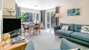 A living room with a TV, sofa, and dining area. - 2 Bed in Lynton (oc-p13830) (Barbrook)