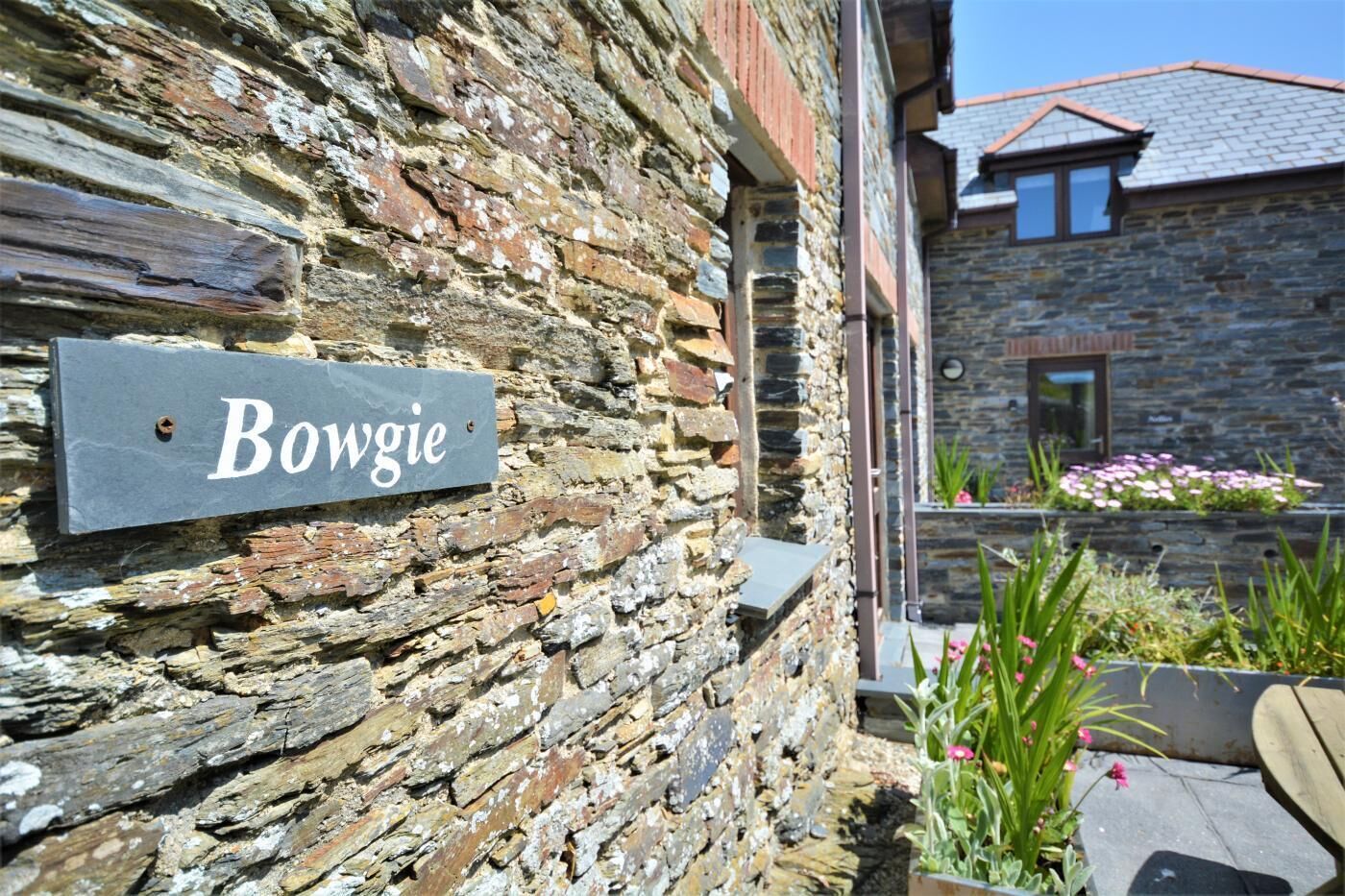 A stone building with a sign reading "Bowgie."