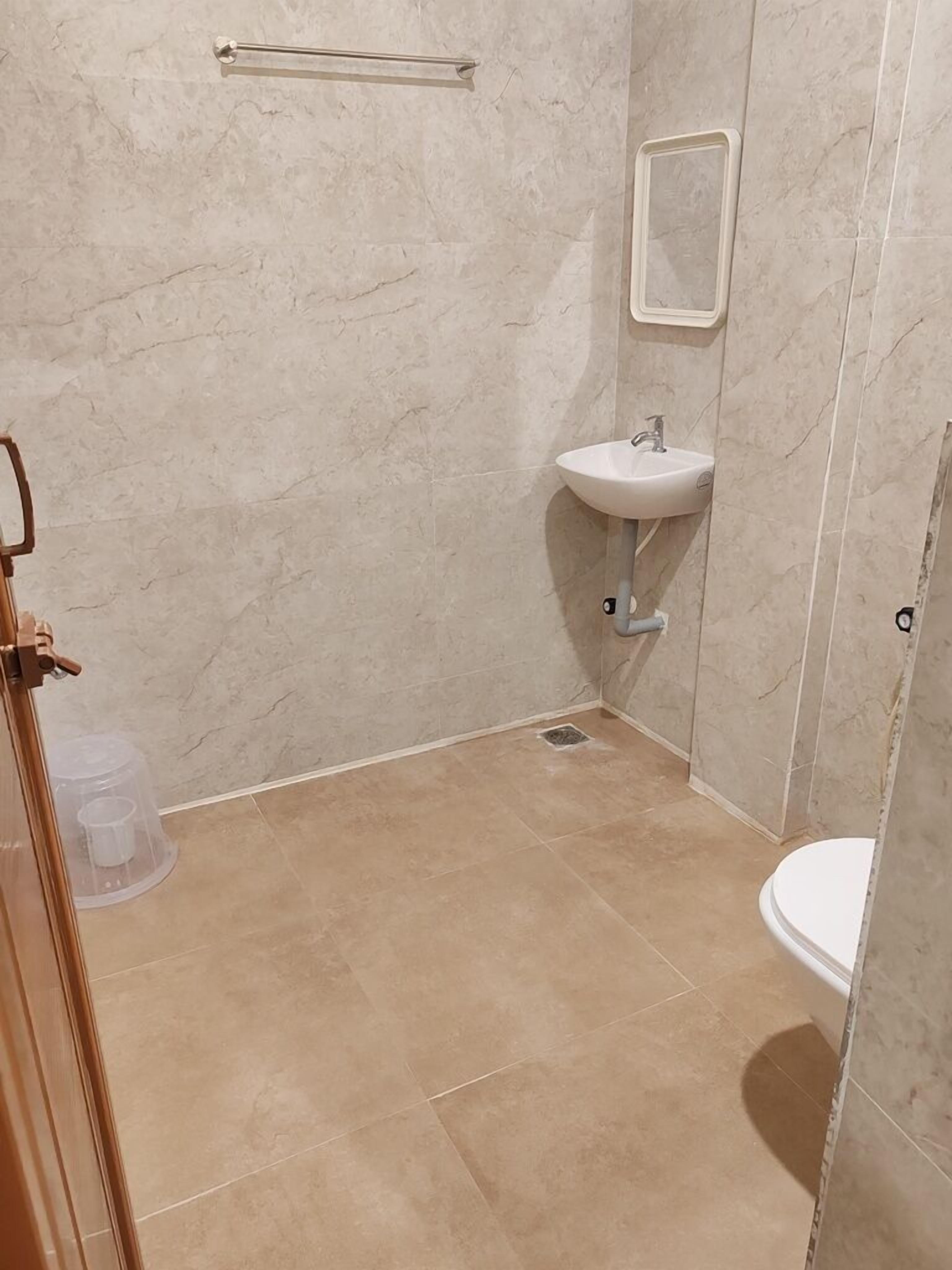 A bathroom with a sink, mirror, and toilet.