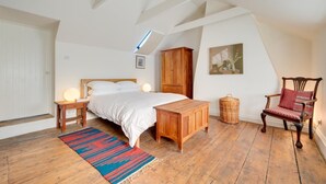 A bedroom with a bed, wooden furniture, a chair, a small table, and a rug. - 2 Bed in Walsham-le-Willows (oc-gabpla) (Walsham le Willows)