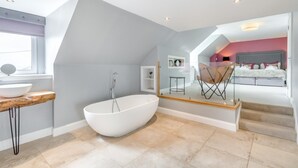 A modern bathroom with a freestanding bathtub, a wooden vanity, and a large window. - 1 Bed in Newburgh (oc-h32593) (Newburgh)