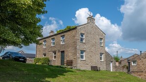 A stone building with multiple windows and a door, surrounded by a grassy area and a tree. - 3 Bed in Bainbridge (oc-ds1026) (Bainbridge)