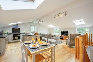 A spacious living area with a dining table set for breakfast, a kitchen with modern appliances, and a cozy seating area with a TV. - 2 Bed in Crook (oc-s32614) (Crook)