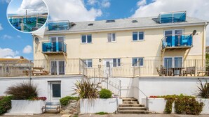 A multi-story building with balconies, a staircase, and a pool area. - 2 Bed in Porthleven (oc-p00972) (Porthleven)