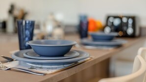A dining table with blue plates and bowls, a knife, and a spoon on a placemat. - 1 Bed in Gilsland (oc-h32687) (Waterhead)