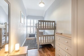 A room with a bunk bed, a dresser, a mirror, and a window with blinds. - 6 Bed in Bacton (oc-2187) (Bacton)