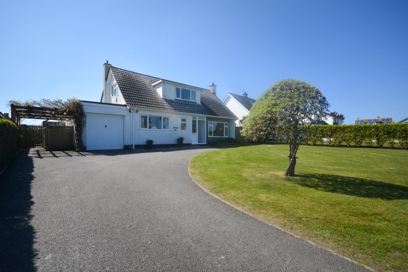 A two-story house with a driveway leading to a garage.