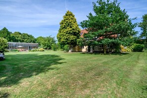 A well-maintained lawn, a large tree, and a house with a red roof. - 4 Bed in St. Nicholas South Elmham (oc-o32397) (All Saints South Elmham)