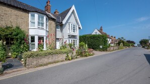A quiet residential street with houses, a clear sky, and a paved road. - 2 Bed in Walberswick (oc-hhock) (Walberswick)