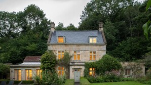 A two-story stone house with a well-maintained garden, a driveway, and a small detached structure. - 7 Bed in Combe Hay (oc-bhr21) (Combe Hay)