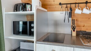 A compact kitchenette with a microwave, toaster, and a small countertop.
