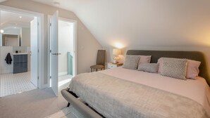 A bedroom with a bed, bedside table, lamp, and a view of the bathroom. - 2 Bed in Holt (oc-l31797) (Holt)