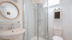 A bathroom with a glass-enclosed shower, a sink, a toilet, and a mirror with a wooden frame. - 2 Bed in Betws Y Coed (oc-wag474) (Betws-y-coed)