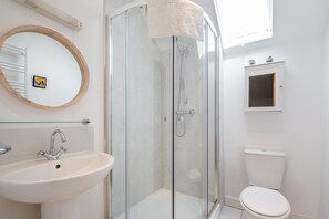A bathroom with a glass-enclosed shower, a sink, a toilet, and a mirror with a wooden frame. - 2 Bed in Betws Y Coed (oc-wag474) (Betws-y-coed)