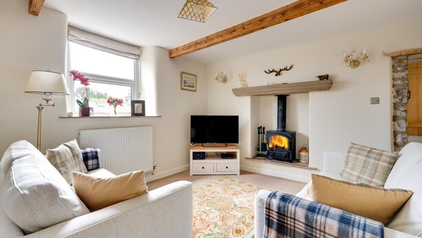 A cozy living room with a fireplace, two sofas, a TV, and a window with a view. - 2 Bed in Buxton (oc-dcwyn) (Tideswell)