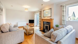 A modern living room with a fireplace, sofa, and television. - 2 Bed in Pickering (oc-d32743) (Pickering)