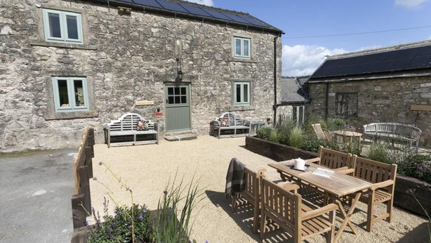 A stone building with a gravel patio, outdoor seating, and solar panels. - 2 Bed in Brassington (oc-dcgol) (Brassington)