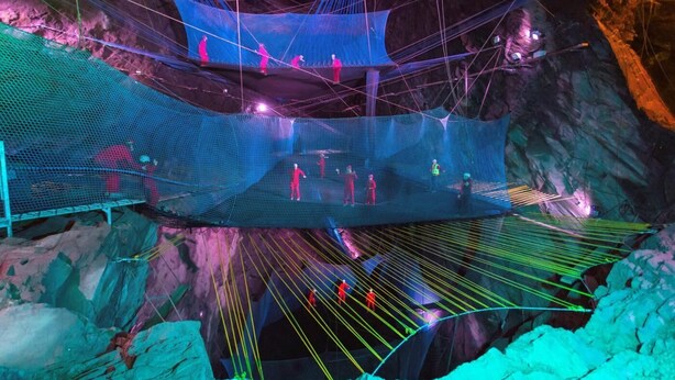 A large, suspended net structure in a cave with people climbing and walking on it. - 3 Bed in Tywyn (oc-h32633) (Tywyn)