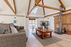 Un salon spacieux avec un canapé, une table basse et une cheminée.