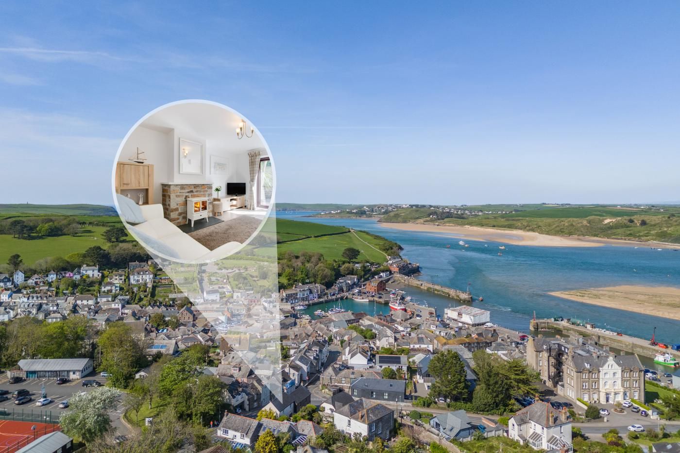 A coastal town with a view of the sea and a zoomed-in inset of a cozy interior with a fireplace.