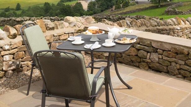 A table set for two with a view of a valley and river. - 3 Bed in Low Row (oc-ds1030) (Low Row)