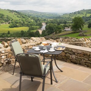 A table set for two with a view of a valley and river. - 3 Bed in Low Row (oc-ds1030) (Low Row)