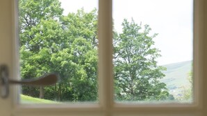 A window with a stone wall and a grassy field. - 3 Bed in Low Row (oc-ds1030) (Low Row)