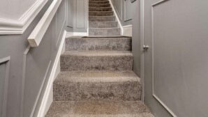 A staircase with carpeted steps leading to a landing. - 1 Bed in Whitby (oc-w121) (Whitby)